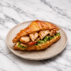 Golden croissant sandwich with grilled chicken