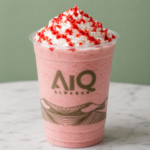 Pink smoothie with whipped cream swirl
